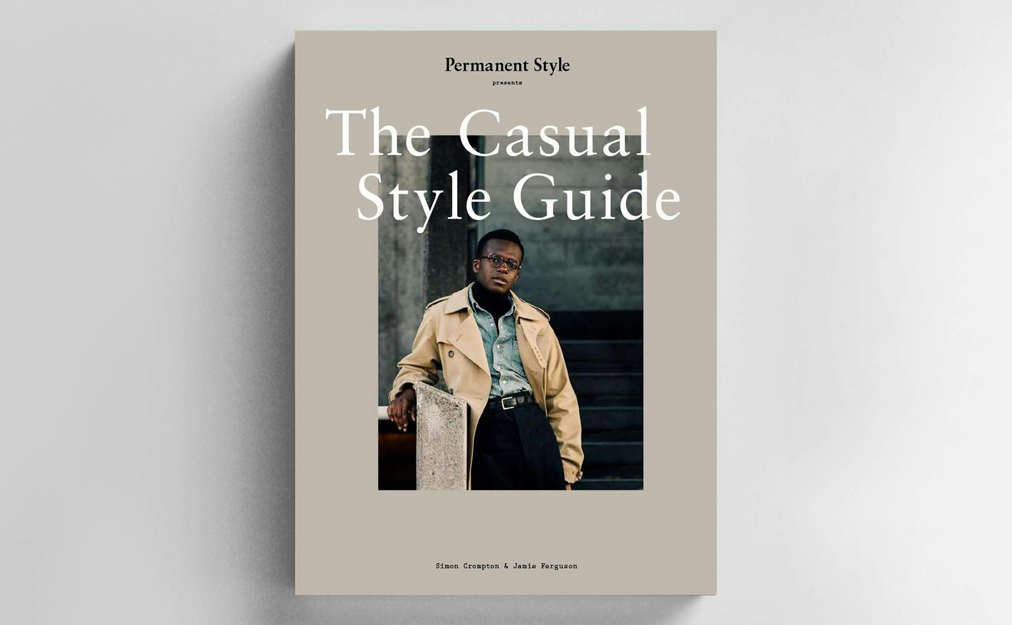 A tan book with a photo of a casually stylish man wearing glasses on the cover.