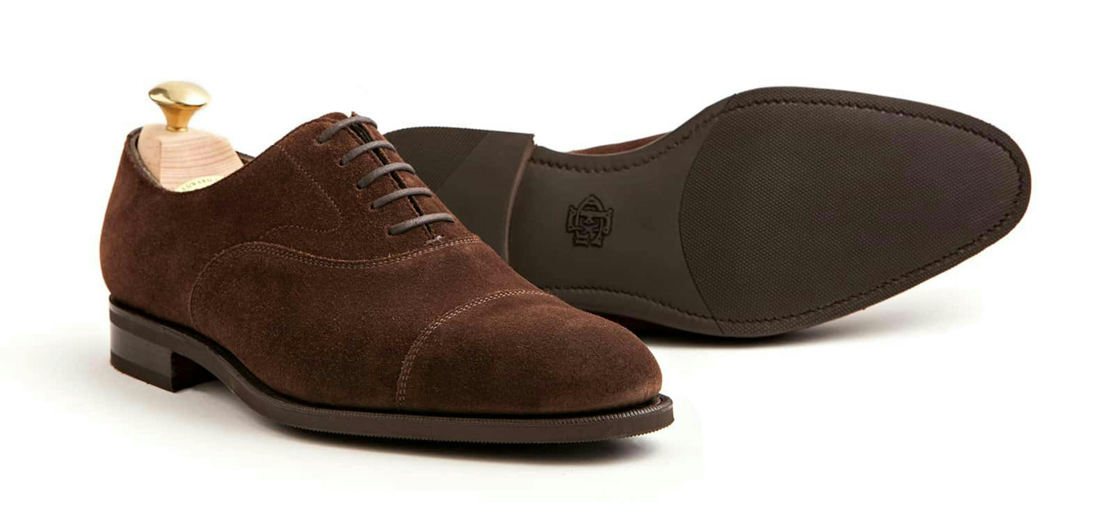 An Edward Green Chelsea in mink suede, with a view of its R1 rubber soles.